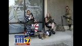 Armed civilians stand guard outside recruiting office _7722423
